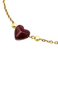 Pulsera de cadena de oro con una gema en forma de corazón de color rojo intenso y dos acentos esféricos de oro. Textura suave con un acabado pulido.