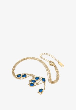 Kultaketju, jossa seitsemän soikeaa sinistä jalokiveä tasaisesti sijoitettu pitkin pituutta, varustettuna hummerilukolla ja säädettävällä jatkoketjulla.