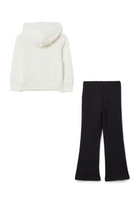 Katoenen hoodie in gebroken wit met een capuchon en geribde manchetten, gecombineerd met zwarte flare leggings, beide met een zachte textuur.