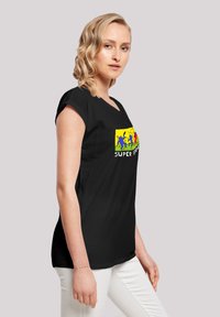 Black short-sleeve t-shirt featuring colorful graphic design with blue, red, and yellow elements and the text "SUPER." Casual fit.