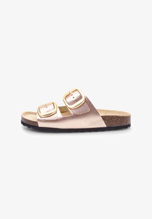 Two-strap slide sandal in metallic rose gold with gold-tone buckles, cork footbed, and a textured black rubber outsole.