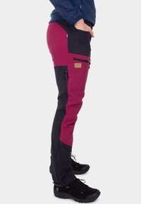 Hiking pants feature a color block design with maroon and black sections, multiple zippered pockets, and durable fabric.