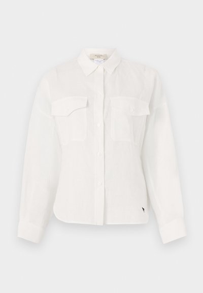 White button-up shirt made of lightweight fabric, featuring two chest pockets, a pointed collar, and a curved hem. Subtle texture detail.