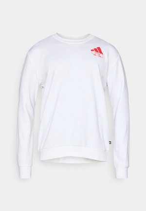 Balts džemperis, izgatavots no mīksta auduma, ar apaļu izgriezumu, garām piedurknēm un sarkanu logotipu augšējā kreisajā stūrī. Vienkāršs, tīrs dizains.