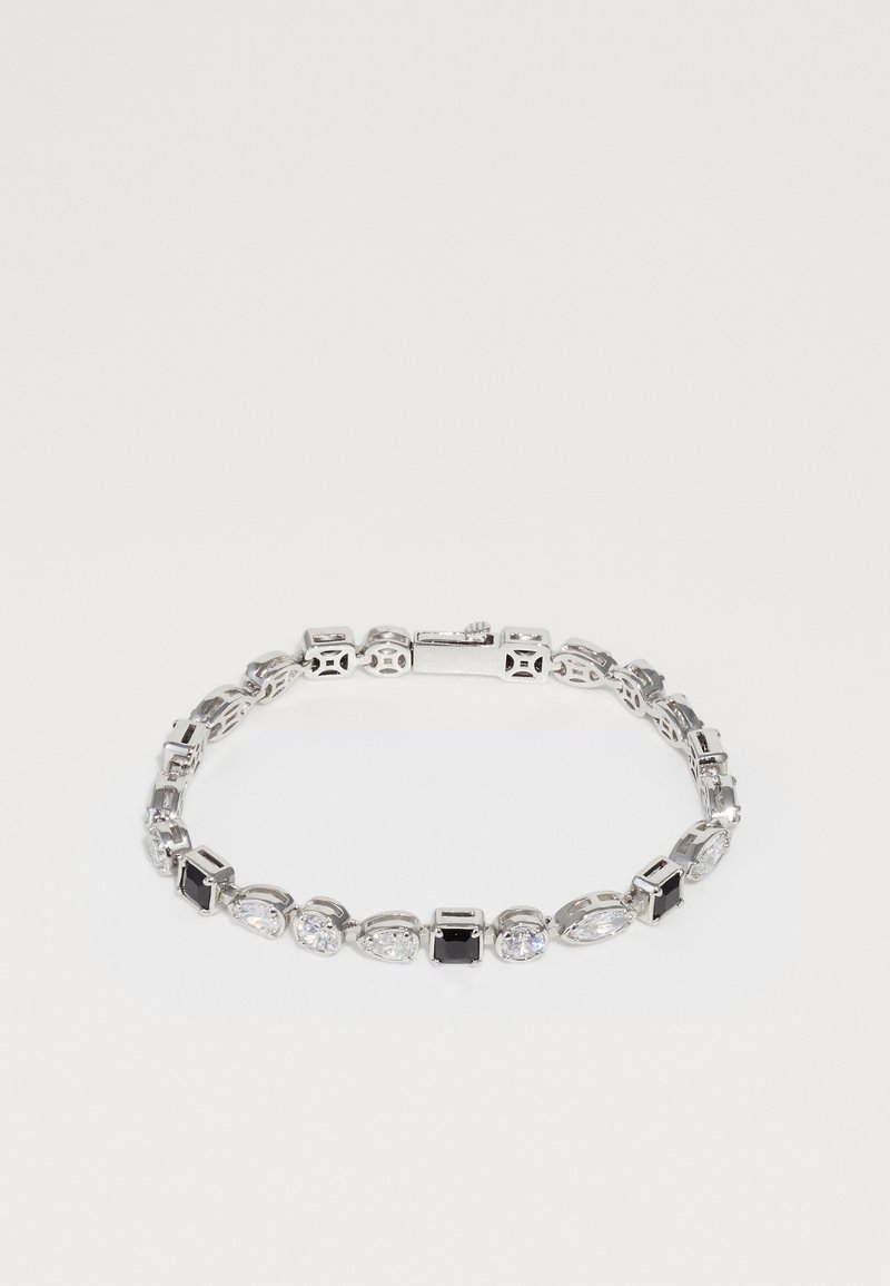 Silver-tone bracelet featuring alternating clear and black gemstones in various cuts. Intricate links with an openwork design.