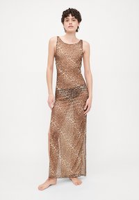 Leopard print maxi dress, sheer fabric, sleeveless design, side slit, earthy tones of brown and beige, smooth texture.