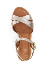 Metallic gold cross-strap sandal with a brown cushioned insole and gold hardware. Features a textured strap and an adjustable ankle buckle.