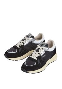 Black and gray sneakers with suede and mesh materials, cream midsole, reflective silver accents, and white laces. Features a textured sole.