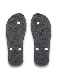 Semelles en caoutchouc noir avec une surface texturée ornée de motifs et trois trous circulaires pour la ventilation ou l'attache.