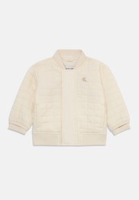 Veste matelassée crème avec un col et des poignets c�ôtelés. Comprend une fermeture avant, des poches latérales et un petit logo sur la poitrine.