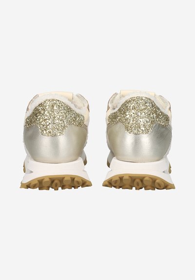 Sneakers with a glittery gold and silver upper, textured white accents, and a gray rubber sole with traction lugs, showing rear view.