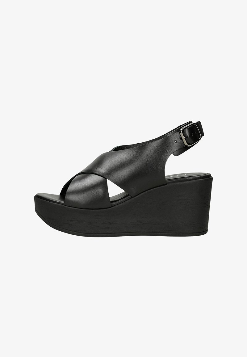 Sandale compensée en cuir noir avec brides croisées et fermeture boucle réglable à la cheville.
