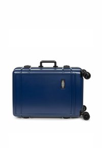Hard-shell suitcase in navy blue, featuring a textured surface, four black wheels, and a retractable handle. Includes a brand logo detail.