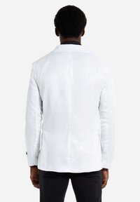 Weißer Pailletten-Blazer mit strukturiertem Finish, einreihigem Design und dezentem Glanz. Verfügt über mit Revers und geknöpfte Manschetten.