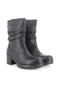 Botas de cuero negro hasta el tobillo con un diseño desgarbado, puntera redonda y un robusto tacón cuadrado. Cuenta con una suela de goma texturizada para mayor agarre.