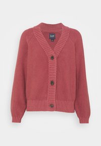 Długi kardigan z koralowego dzianego materiału z długim rękawem, dekoltem w serek, zapięciem na guziki oraz ściągaczami na dole i mankietach. Charakteryzuje się fakturowaną tkaniną i brązowymi guzikami.