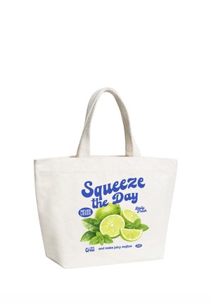 White tote bag with handles featuring text "Squeeze the Day" and images of sliced limes and mint leaves.