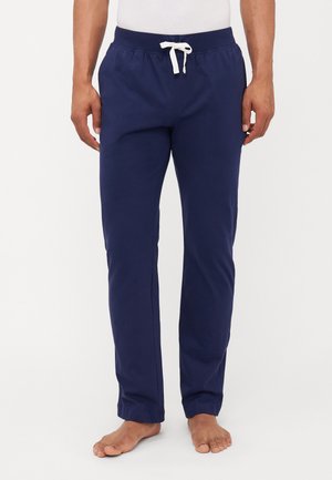 Pantaloni jogger in cotone blu navy con una comoda vita elastica, coulisse bianca e tasche laterali, caratterizzati da un design a gamba affusolata.