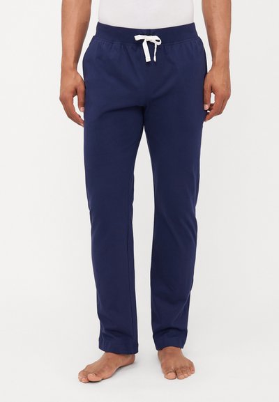 Marineblaue Baumwoll-Jogginghose mit einem bequemen elastischen Bund, weißem Kordelzug und Seitentaschen, ausgestattet mit einem schmal zulaufenden Bein-Design.
