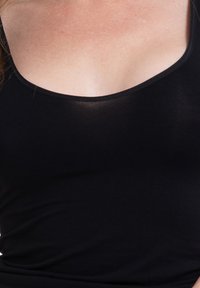 Black sleeveless top made of soft, stretchy fabric with a rounded neckline and smooth texture. No visible patterns or embellishments.