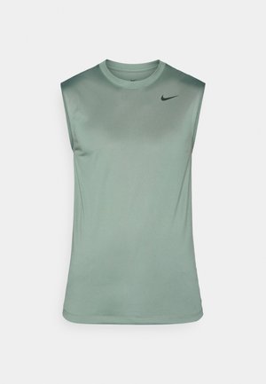 Sleeveless athletic shirt in soft green fabric with a smooth texture. Features a round neckline and a small black Nike logo on the chest.