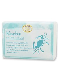 Bar of soap with a textured, pale blue wrapper featuring a crab illustration and text on zodiac sign "Krebs" in a darker blue font.