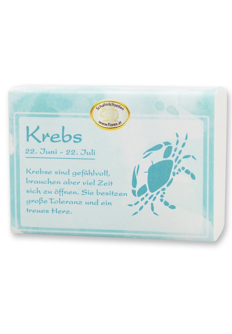 Bar of soap with a textured, pale blue wrapper featuring a crab illustration and text on zodiac sign "Krebs" in a darker blue font.