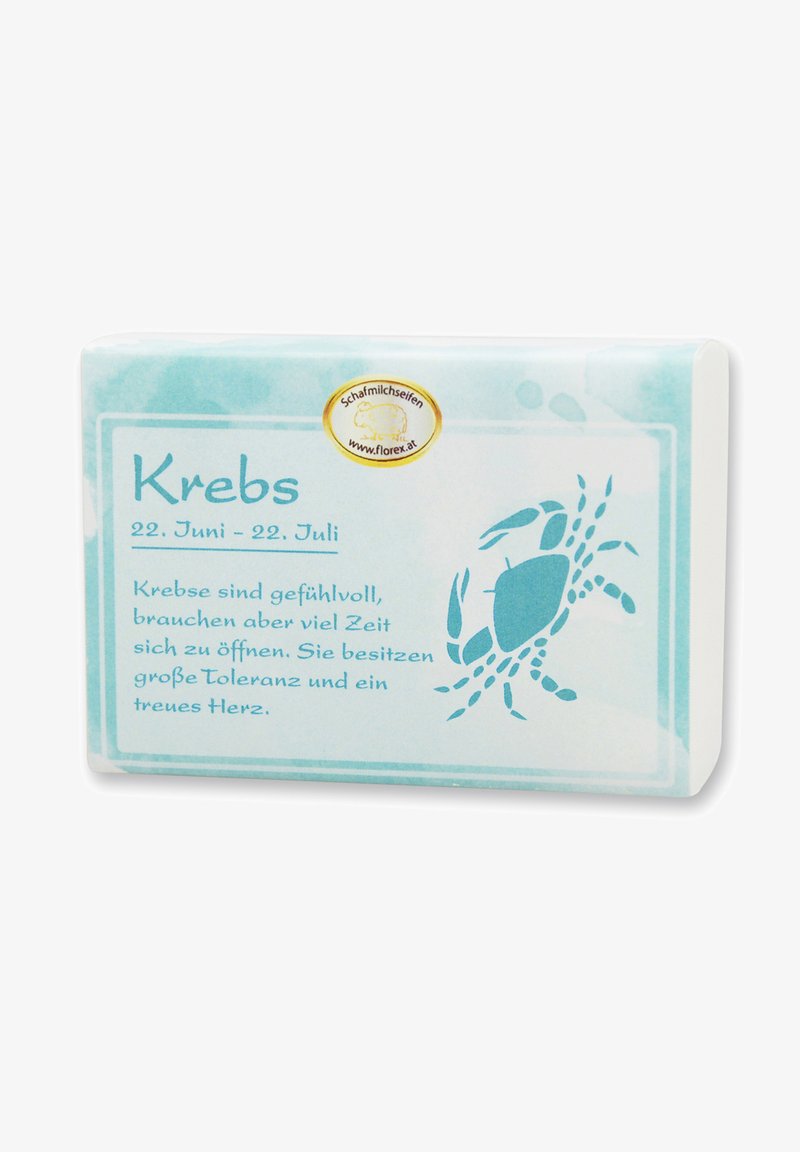 Bar of soap with a textured, pale blue wrapper featuring a crab illustration and text on zodiac sign "Krebs" in a darker blue font.
