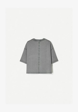 Gray short-sleeve top with a round neckline, boxy shape, visible stitching details, and a soft, textured fabric finish.