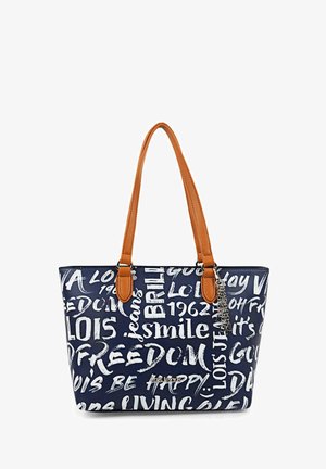 Bolso de mano azul marino con letras blancas, asas beige y detalles de charm. Presenta una forma rectangular y una textura suave, destacando varias frases.