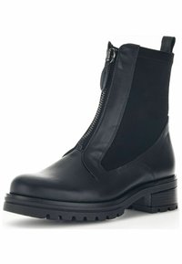 Zwarte enkelboot met glad leer, elastische zijpanelen, een zijrits en een robuuste zool. Blokhak voor stabiliteit en ondersteuning.