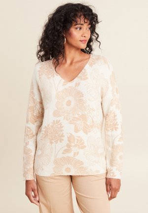 Un pull léger en crème avec un col en V, des manches longues et un motif floral en beige doux. Tissu texturé avec une coupe décontractée.