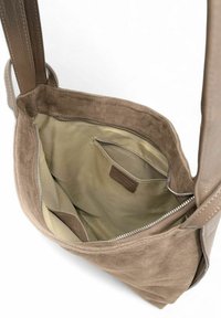 Sac à épaule en daim brun avec une fermeture éclair, doublure beige, poche intérieure et anses plates.