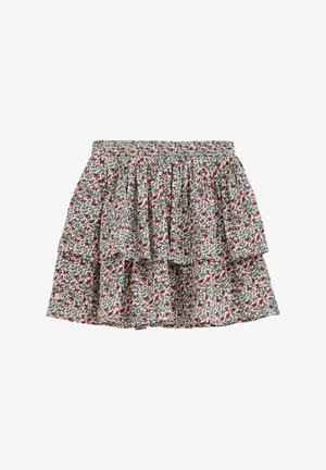 Lag-på-lag nederdel med blomsterprint og elastisk talje i rød, grøn og hvid på en ensfarvet baggrund.
