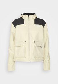 Béžová a černá kapucňová bunda s plným zipem, dvěma předními kapsami na klopu a logem The North Face na hrudi.