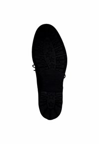 Schwarze Gummisohle eines Schuhs mit strukturiertem Profil, das Sternmuster und kleine Rillen für besseren Halt aufweist, entworfen für Langlebigkeit und Traktion.