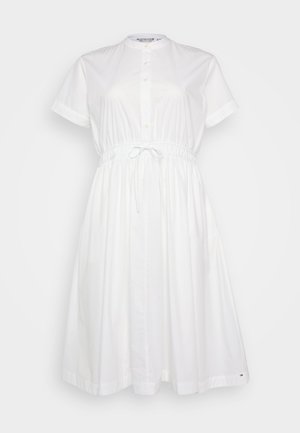 White cotton dress with short sleeves, button front, elastic waist, and adjustable drawstring; features a loose, flowing fit.