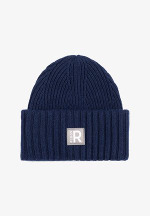 Navy blue ribbed knit beanie with folded cuff featuring a square gray patch labeled "#1839 R" on front.