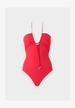 Červené jednodílné plavky s tenkými ramínky, hlubokým výstřihem a ozdobnými zlatými tkaničkami na hrudi.