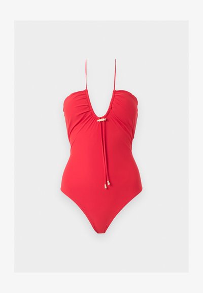 Κόκκινο ολόσωμο μαγιό με λεπτές τιράντες, βαθύ ντεκολτέ και διακοσμητικούς δεσίμους με χρυσαφένιες λεπτομέρειες στο στήθος.