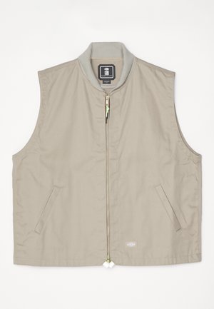 Gilet sans manches beige avec un col côtelé, fermeture éclair à l'avant, deux poches latérales et un patch logo en bas à droite.