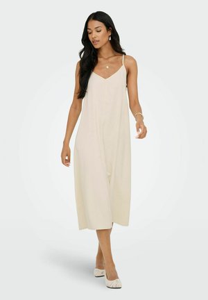 Ljust beige, knälång klänning med justerbara tunna remmar, V-ringning och en flödande design. Slät, mjuk tyg med en minimalistisk stil.