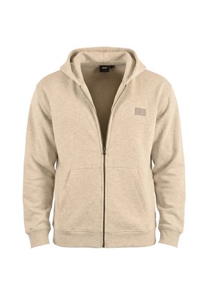 Sweat à capuche zippé beige avec poches à l'avant et petit patch logo rectangulaire sur la poitrine.