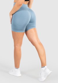 Hoge taille, lichtblauwe shorts gemaakt van rekbaar materiaal, met een zachte textuur en een fitted ontwerp met een lengte tot halverwege de dij.