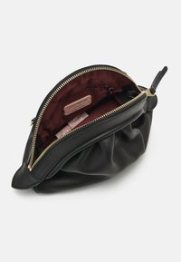 Black leather bag with a gathered design, gold zipper, and burgundy interior lining. Includes labels for brand identification.