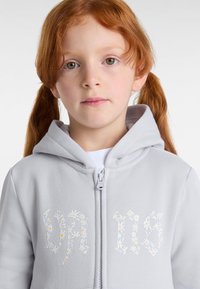 Light gray zip-up hoodie featuring floral letters with daisies in white and yellow, soft fabric, and a hood with a simple design.