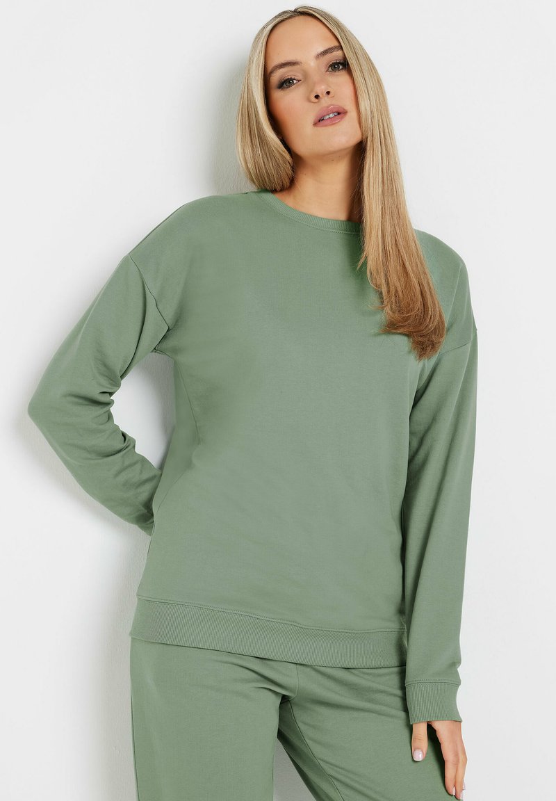 Felpa verde chiaro in morbido tessuto, con collo rotondo, maniche lunghe e polsini e orlo a costine. Design semplice e rilassato senza motivi.