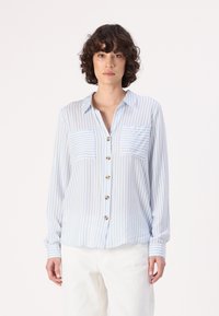 Light blue and white striped button-up shirt with two chest pockets, soft fabric, and long sleeves, featuring round golden buttons.