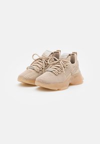 Beige athletic shoes made of breathable mesh, featuring textured detailing, elastic laces, and a clear outsole with a cushioned design.