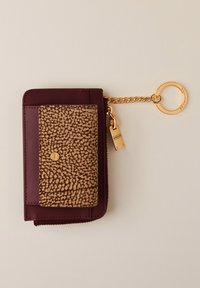 Burgundy leather wallet with a textured brown panel. Features a gold chain and keyring, zip closure, and a decorative clasp.